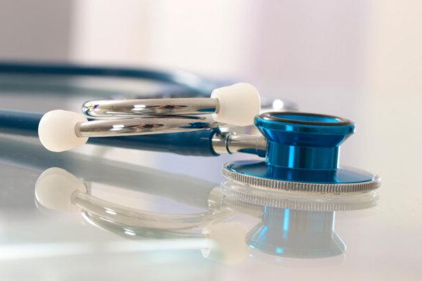 Stock image of a stethoscope on a table.